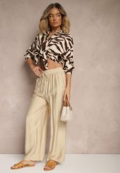 Beżowe Spodnie Typu Palazzo o Szerokim Kroju High Waist Ozdobione Wiązaniem Yaslevia. Brązowe jeansy Renee, bez wzorów, z jeansu, eleganckie, z podwyższonym stanem. W wyprzedaży za 29.99 zł.