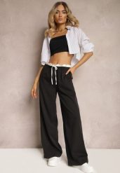 Czarne Materiałowe Spodnie z Szerokimi Nogawkami High Waist z Gumką w Talii Comina. Czarne jeansy Renee, bez wzorów, z jeansu, eleganckie, z podwyższonym stanem. W wyprzedaży za 111.99 zł.