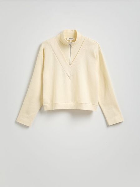 Bluza z rozpinanym półgolfem - złamana biel. Bluzy Reserved, l, bez wzorów, z bawełny, bez ramiączek, bez kaptura. W wyprzedaży za 79.99 zł.