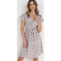 Biała Sukienka Aerike. Białe sukienki Born2be, m, z aplikacjami, z materiału, bez kołnierzyka, bez ramiączek, mini, kopertowe. W wyprzedaży za 48.99 zł.