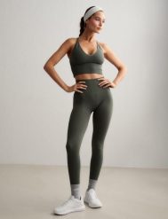 Damskie legginsy invisible scrunch, squat proof Shape Seamless zielone. Zielone legginsy AIM'N, bez wzorów, z dzianiny. Za 296.00 zł.