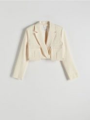 Krótka marynarka z dodatkiem lnu - kremowy. Białe marynarki i żakiety Reserved, l, bez wzorów, z tkaniny, bez ramiączek. W wyprzedaży za 99.99 zł.