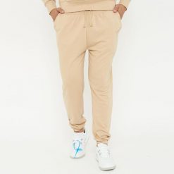 Spodnie sportowe unisex F BALLON beżowe. Brązowe spodnie dresowe LEGEA, bez wzorów, z gumy, na fitness i siłownię. W wyprzedaży za 92.00 zł.