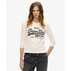 Top graficzny z długim rękawem Vl ozdobiony. Białe bielizna termoaktywna damska Superdry, bez wzorów, bez ramiączek. W wyprzedaży za 194.70 zł.