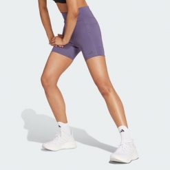 Legginsy Own the Run Short. Fioletowe legginsy adidas, bez wzorów, z materiału, sportowe. W wyprzedaży za 170.82 zł.