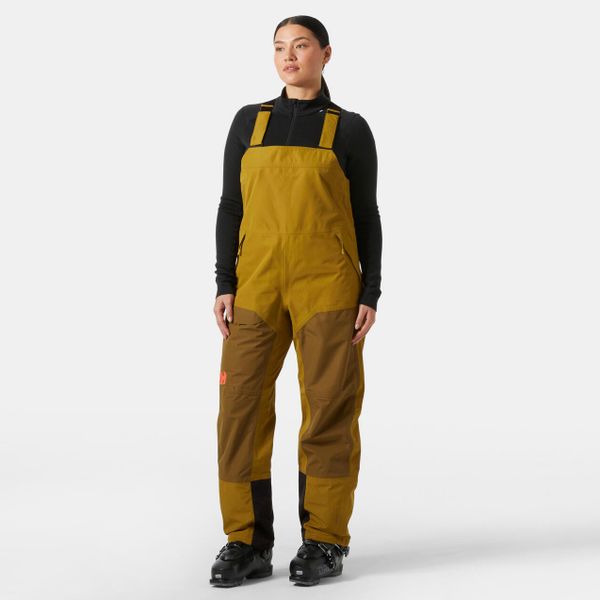 Damski kombinezon narciarski Helly Hansen Emiko Shell Bib. Brązowe kombinezony Helly Hansen, na zimę, bez wzorów, sportowe, bez kołnierzyka, bez ramiączek. Za 1,036.50 zł.