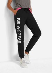 Spodnie sportowe bawełniane z nadrukiem, Loose Fit. Czarne spodnie dresowe bonprix, bez wzorów, z bawełny. Za 114.99 zł.