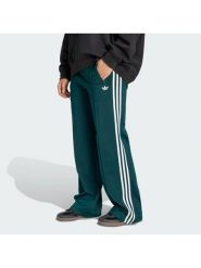 Adidas Spodnie dresowe Firebird KG3701 Zielony Loose Fit. Zielone spodnie dresowe adidas, bez wzorów, z dresówki. Za 299.99 zł.
