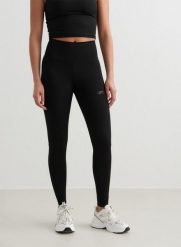 Damskie legginsy z wysokim stanem, odprowadzające pot Sculpting czarne. Czarne legginsy AIM'N, bez wzorów, z lycry, eleganckie. Za 339.00 zł.
