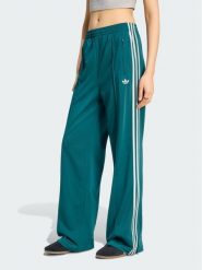 Adidas Spodnie dresowe FIREBIRD Zielony Loose Fit. Zielone spodnie sportowe adidas, bez wzorów, z dresówki. Za 298.99 zł.