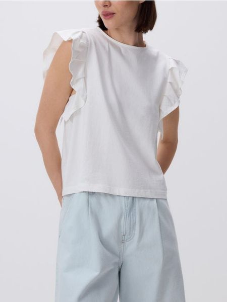 Bluzka z falbanami - biały. Białe bluzki Reserved, l, bez wzorów, z bawełny, bez kołnierzyka, bez ramiączek. W wyprzedaży za 17.99 zł.