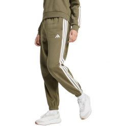Spodnie damskie adidas Essentials 3-Stripes Fleece Loose-Fit. Zielone spodnie materiałowe adidas, bez wzorów, z bawełny, sportowe. Za 171.99 zł.