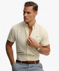Superdry Koszula Preppy Oxford krótki rękaw Pastel Yellow Chambray. Żółte koszule Superdry, uniwersalny, bez wzorów, z bawełny, klasyczne, bez kołnierzyka, bez ramiączek. Za 314.00 zł.