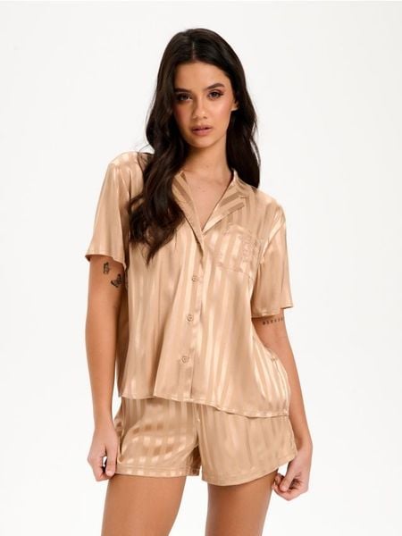 Piżama dwuczęściowa Winnie The Pooh - beżowy. Brązowe piżamy Sinsay, l, bez wzorów, bez kołnierzyka, bez ramiączek. Za 59.99 zł.