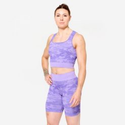 Koszulka fitness damska Domyos crop top. Fioletowe topy DOMYOS, l, bez wzorów, z elastanu, sportowe, bez kołnierzyka, bez ramiączek. Za 89.99 zł.