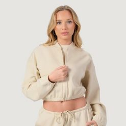 Bluza damska fitness z zamkiem bez kaptura migdałowa NEO. Brązowe bluzy GYMBEAM, l, bez wzorów, z bawełny, sportowe, bez ramiączek, bez kaptura. Za 116.90 zł.