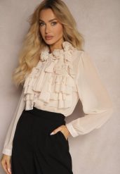 Beżowa Prześwitująca Koszula z Falbankami i Kwiatowym Zdobieniem przy Dekolcie Raivona. Brązowe koszule Renee, l, z aplikacjami, z jeansu, eleganckie, bez kołnierzyka, bez ramiączek. W wyprzedaży za 127.99 zł.