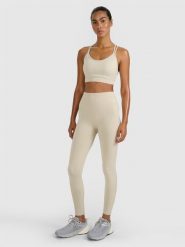 4F Legginsy treningowe bezszwowe damskie - beżowe M/L. Brązowe legginsy 4f, bez wzorów, z dzianiny, klasyczne. Za 129.99 zł.