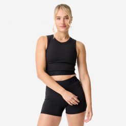 Koszulka fitness damska Domyos crop top. Czarne topy sportowe DOMYOS, l, bez wzorów, z elastanu, na fitness i siłownię. Za 69.99 zł.
