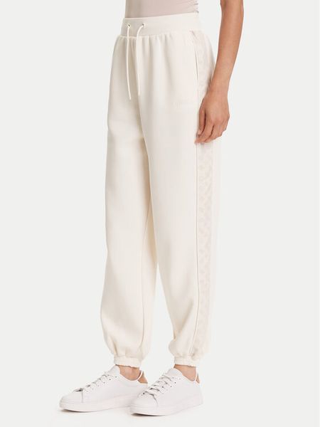 Guess Spodnie dresowe V5YB02 KB3P2 Écru Regular Fit. Spodnie dresowe Guess, z aplikacjami, z dresówki. Za 299.99 zł.