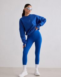 Damskie legginsy biegowe 7/8 wysoki stan, squat proof, kieszenie Le Run lazurowe. Niebieskie legginsy AIM'N, bez wzorów, z elastanu. Za 381.00 zł.