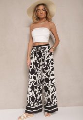 Czarne Spodnie o Szerokim Kroju High Waist w Kwiaty Nelrive. Czarne jeansy Renee, z aplikacjami, z jeansu, eleganckie, z podwyższonym stanem. W wyprzedaży za 35.99 zł.
