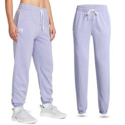 Spodnie dresowe damskie Under Armour Rival Terry Joggers joggery. Fioletowe spodnie sportowe Under Armour, bez wzorów, z dresówki, długie. W wyprzedaży za 225.30 zł.