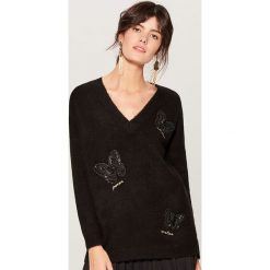Melanżowy sweter z aplikacją - Czarny. Swetry marki DOMYOS. W wyprzedaży za 79.99 zł.