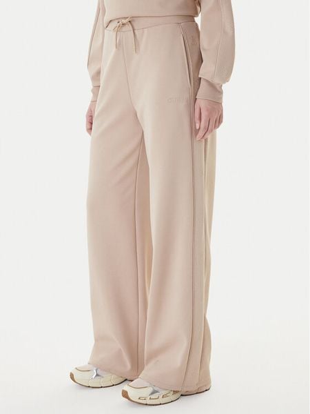 Guess Spodnie dresowe V5BB12 KCX22 Beżowy Regular Fit. Brązowe spodnie dresowe Guess, z aplikacjami, z dresówki. Za 479.99 zł.