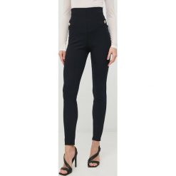 Marciano Guess spodnie damskie kolor granatowy dopasowane medium waist. Niebieskie spodnie materiałowe Marciano Guess, z aplikacjami, z materiału. Za 869.99 zł.