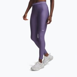 Legginsy treningowe damskie Under Armour HeatGear. Fioletowe legginsy Under Armour, bez wzorów, sportowe. Za 129.99 zł.