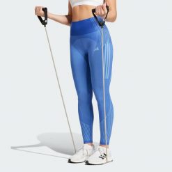 Legginsy Seamless Branded 7/8. Niebieskie legginsy adidas, bez wzorów, z materiału, sportowe. Za 207.75 zł.