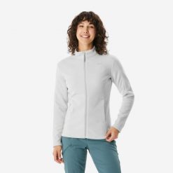Polar turystyczny damski MH 500. Niebieskie bluzy z polaru QUECHUA, l, bez wzorów, z materiału, trekkingowe. W wyprzedaży za 99.99 zł.