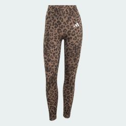 Legginsy Optime Essentials 3-Stripes Leopard 7/8. Brązowe legginsy adidas, bez wzorów, z elastanu. Za 219.00 zł.