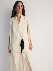 Dwurzędowa marynarka z rozcięciami - kremowy. Białe marynarki i żakiety Reserved, l, bez wzorów, z bawełny, bez ramiączek. W wyprzedaży za 279.99 zł.