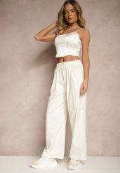 Jasnobeżowe Spodnie o Szerokim Kroju z Bawełną High Waist Ozdobione Naszywką Naneriela. Brązowe jeansy Renee, z aplikacjami, z bawełny, eleganckie, z podwyższonym stanem. W wyprzedaży za 41.99 zł.