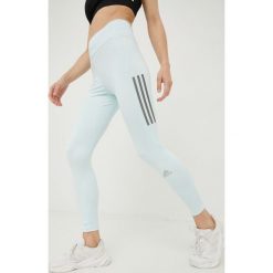 Adidas Performance legginsy do biegania Own The Run damskie z nadrukiem. Niebieskie legginsy adidas Performance, bez wzorów, z materiału. W wyprzedaży za 189.99 zł.
