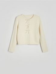 Kardigan z kokardami - kremowy. Białe swetry Reserved, l, bez wzorów, z dzianiny, bez ramiączek. W wyprzedaży za 119.99 zł.