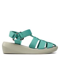 Sandały Fly London. Niebieskie sandały Fly London, bez wzorów, bez obcasa, na koturnie, bez zapięcia. Za 259.99 zł.