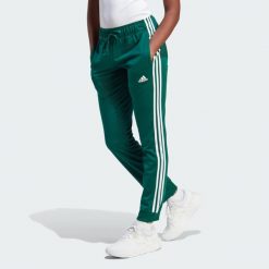 Primegreen Essentials Warm-Up Slim Tapered 3-Stripes Track Pants. Białe spodnie dresowe adidas, bez wzorów, z dresówki. Za 199.00 zł.