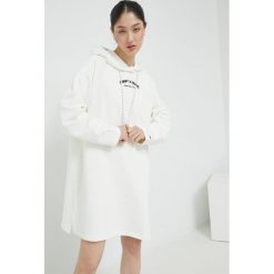 Tommy Jeans sukienka bawełniana kolor beżowy mini oversize. Brązowe sukienki Tommy Jeans, l, bez wzorów, z bawełny, bez kołnierzyka, bez ramiączek, maxi, oversize. Za 489.99 zł.