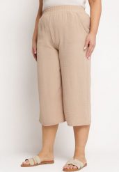 Ciemnobeżowe Szerokie Spodnie z Wysokim Stanem z Gumką w Talii i Nogawkami Długości 3/4 Levolia. Brązowe jeansy Born2be, plus size, bez wzorów, z jeansu, eleganckie, z podwyższonym stanem. Za 54.99 zł.