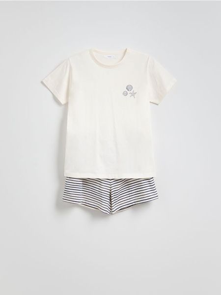 Bawełniana piżama dwuczęściowa - kremowy. Białe piżamy Reserved, l, bez wzorów, z bawełny, bez kołnierzyka, bez ramiączek. W wyprzedaży za 49.99 zł.