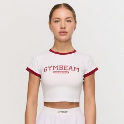 Koszulka damska fitness slim biała Varsity. Białe t-shirty sportowe GYMBEAM, l, bez wzorów, z elastanu, bez ramiączek, na fitness i siłownię. Za 88.90 zł.