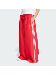 Adidas Spodnie dresowe Firebird Adilenium KD6299 Czerwony Regular Fit. Czerwone spodnie sportowe adidas, bez wzorów, z dresówki. Za 379.99 zł.