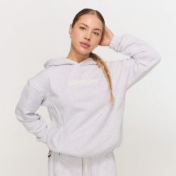 Bluza damska fitness z kapturem szara Varsity. Szare bluzy z kapturem GYMBEAM, l, bez wzorów, z materiału, z kapturem, na fitness i siłownię. Za 139.90 zł.