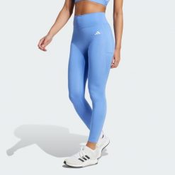 Legginsy 7/8 bez szwu z przodu Optime Essentials. Niebieskie legginsy adidas, bez wzorów, sportowe. Za 219.00 zł.