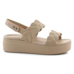 Sandały Crocs Brooklyn Woven Low Wedge 209977-212 beżowy. Brązowe sandały bez wzorów, eleganckie, bez obcasa, na koturnie, bez zapięcia. Za 367.32 zł.