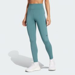 Legginsy Own the Run 7/8. Niebieskie legginsy adidas, bez wzorów, z materiału, eleganckie. W wyprzedaży za 217.62 zł.