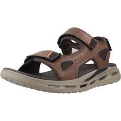 Sandały SKECHERS ORVAN SD GAMBLE Brązowy. Brązowe sandały Skechers, bez wzorów, z materiału, bez obcasa, bez zapięcia. Za 390.00 zł.